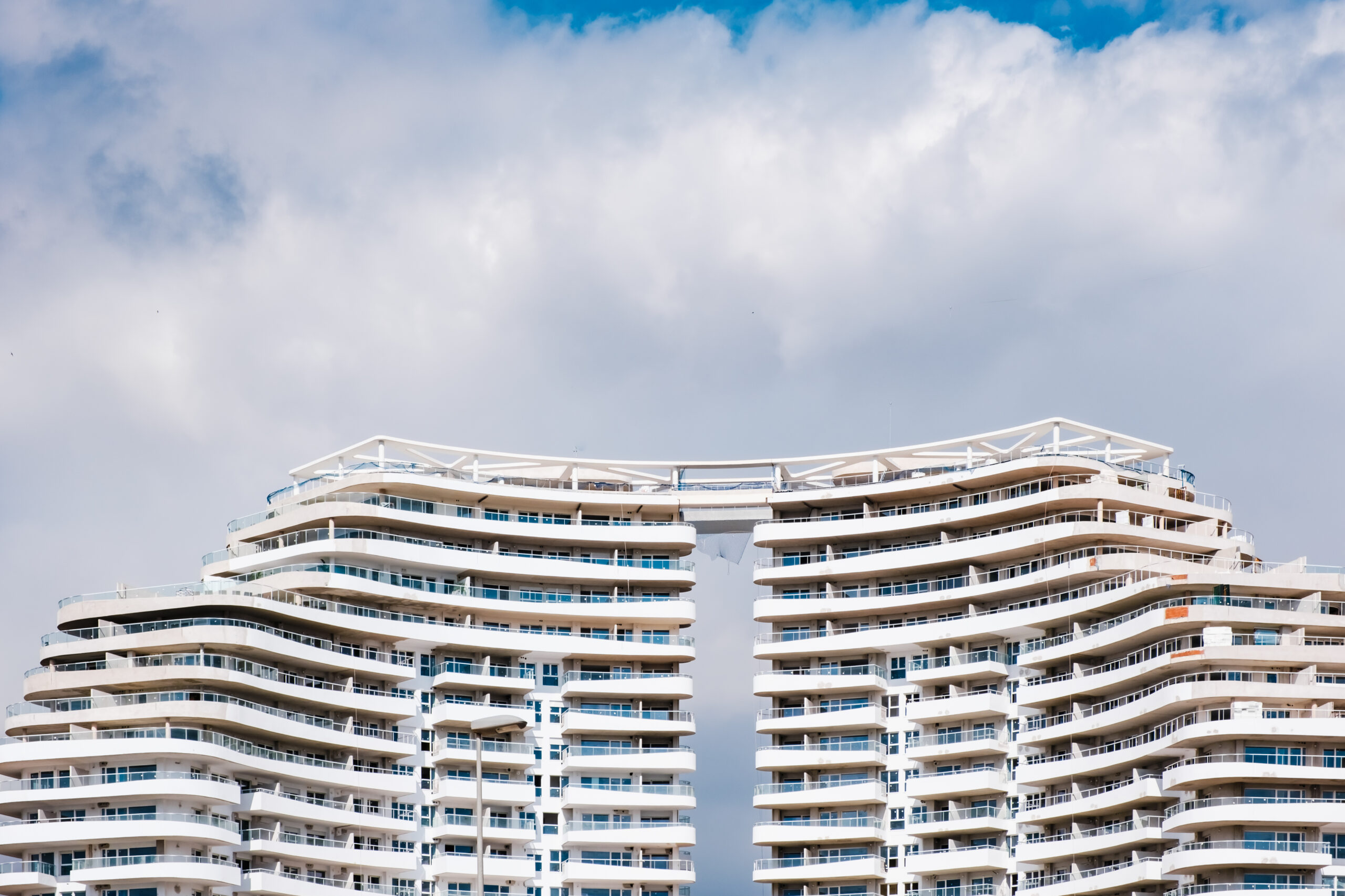 A newly built hotel with large balconies is an area overcrowded by cheap beach tourism.